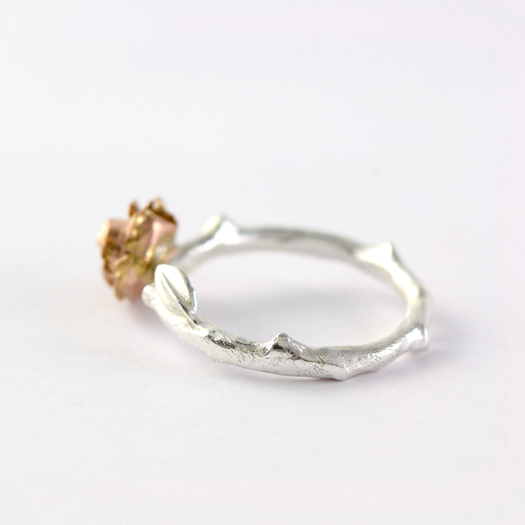 rose stem ring with a 9ct red  gold rose 