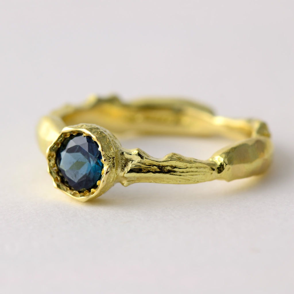 blue gemstone and gold ring 