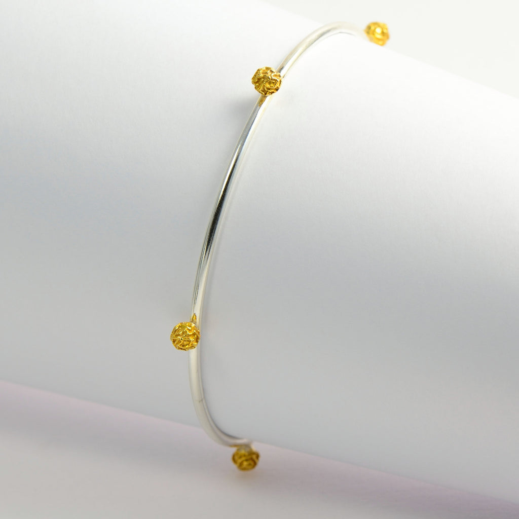 A Set of three bangles, with stellar peppercorns design accented with gold vermiel, dark and bright silver sterling