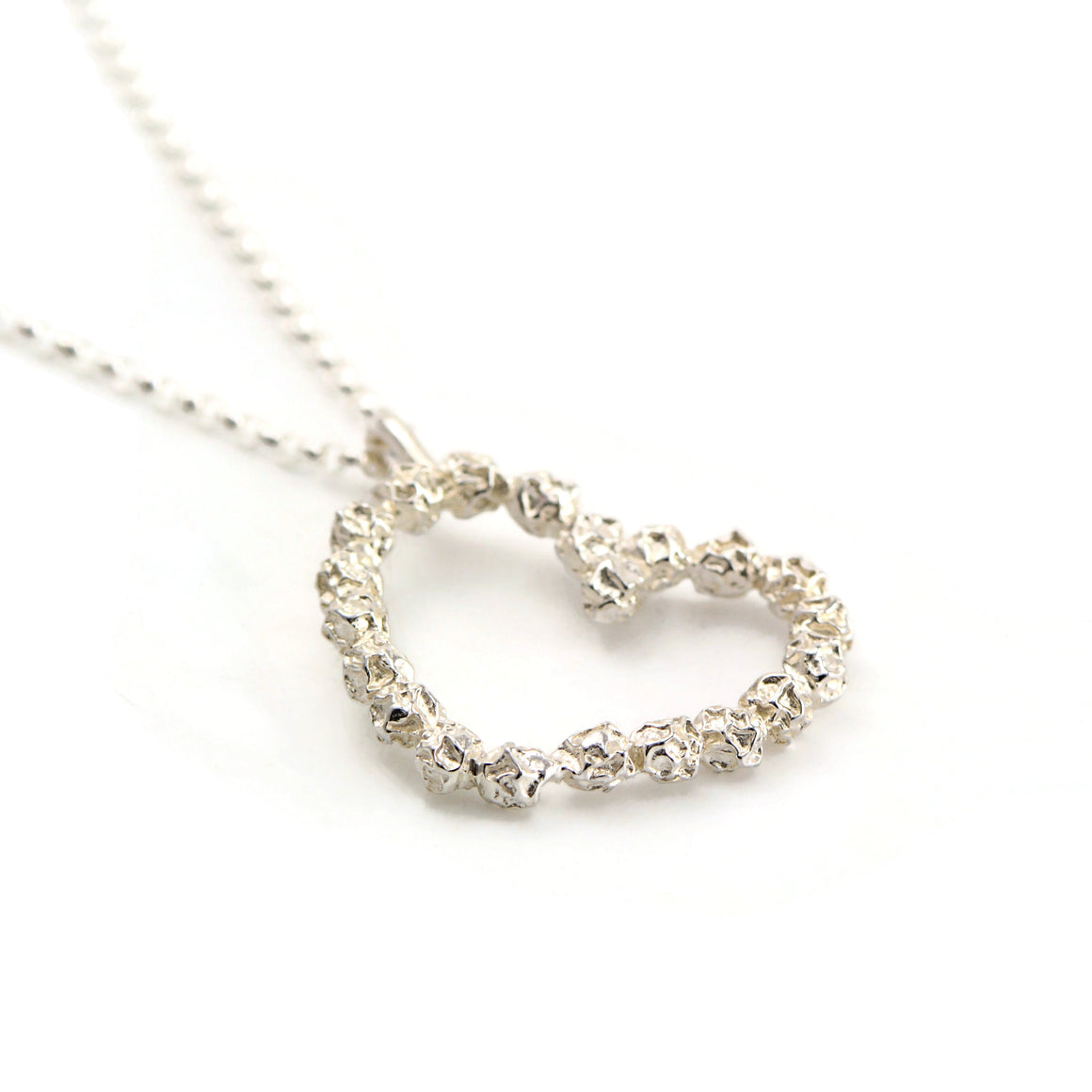 A love heart pendant in solid sterling silver peppercorns