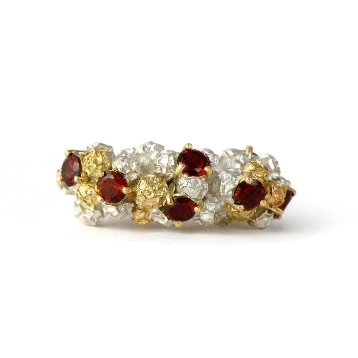 contemporary cock tail ring made in gold, silver and garnets 