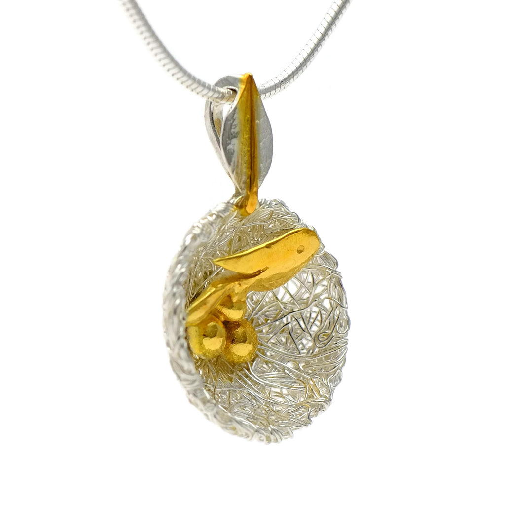 Bird's nest pendant with golden bird and eggs