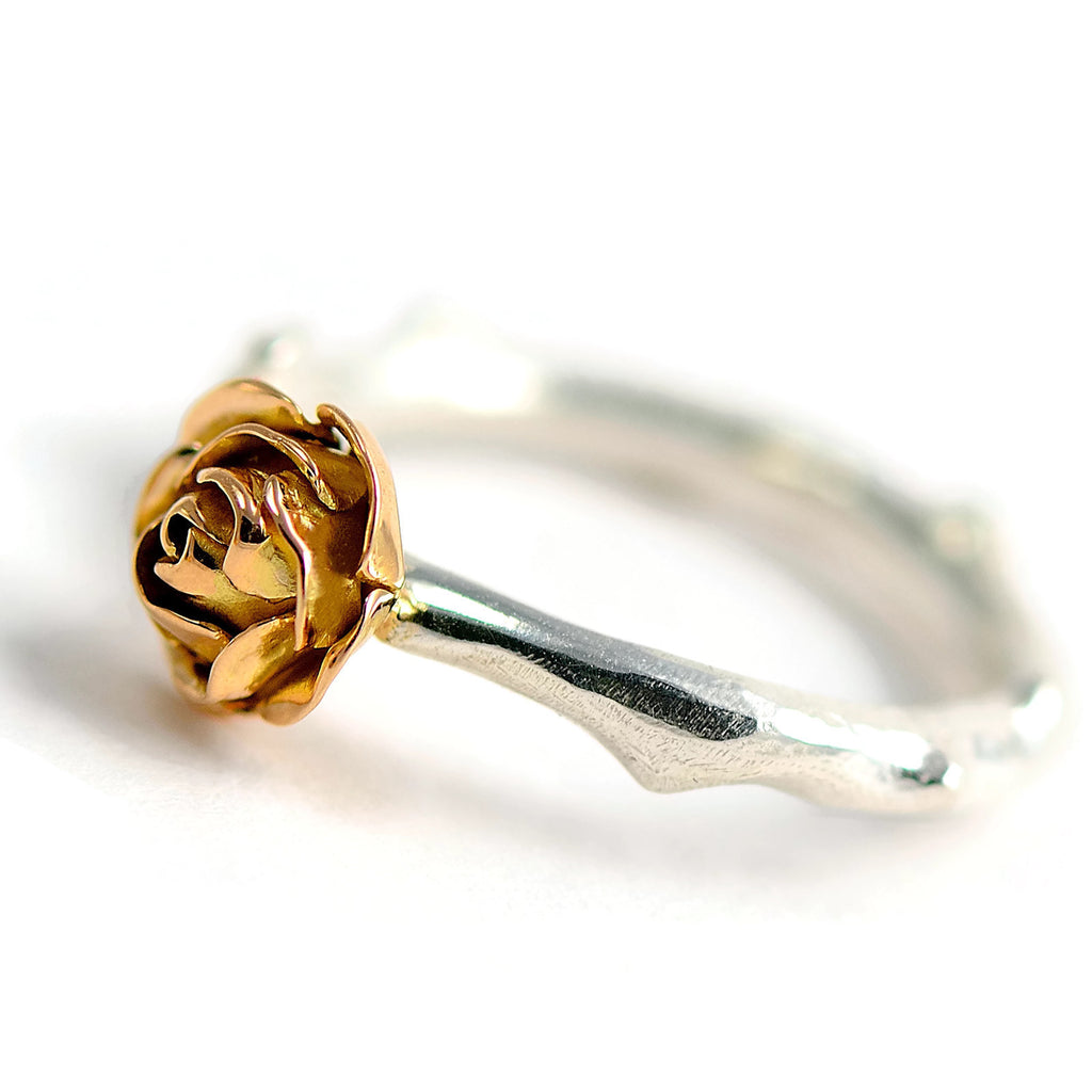 rose stem ring with a 18ct red  gold rose 