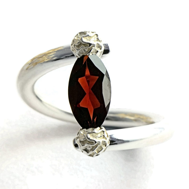 Tension set ring with a marquise garnet 