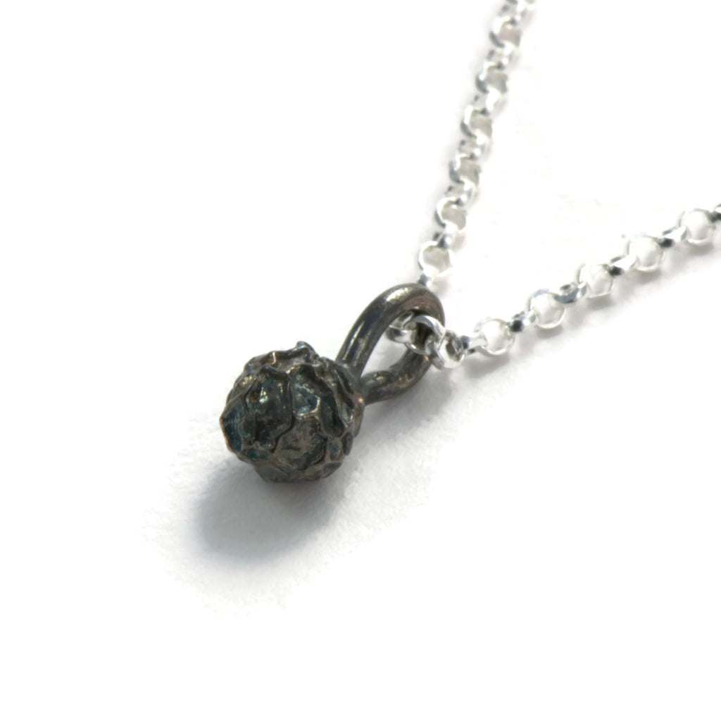 A silver peppercorn pendant